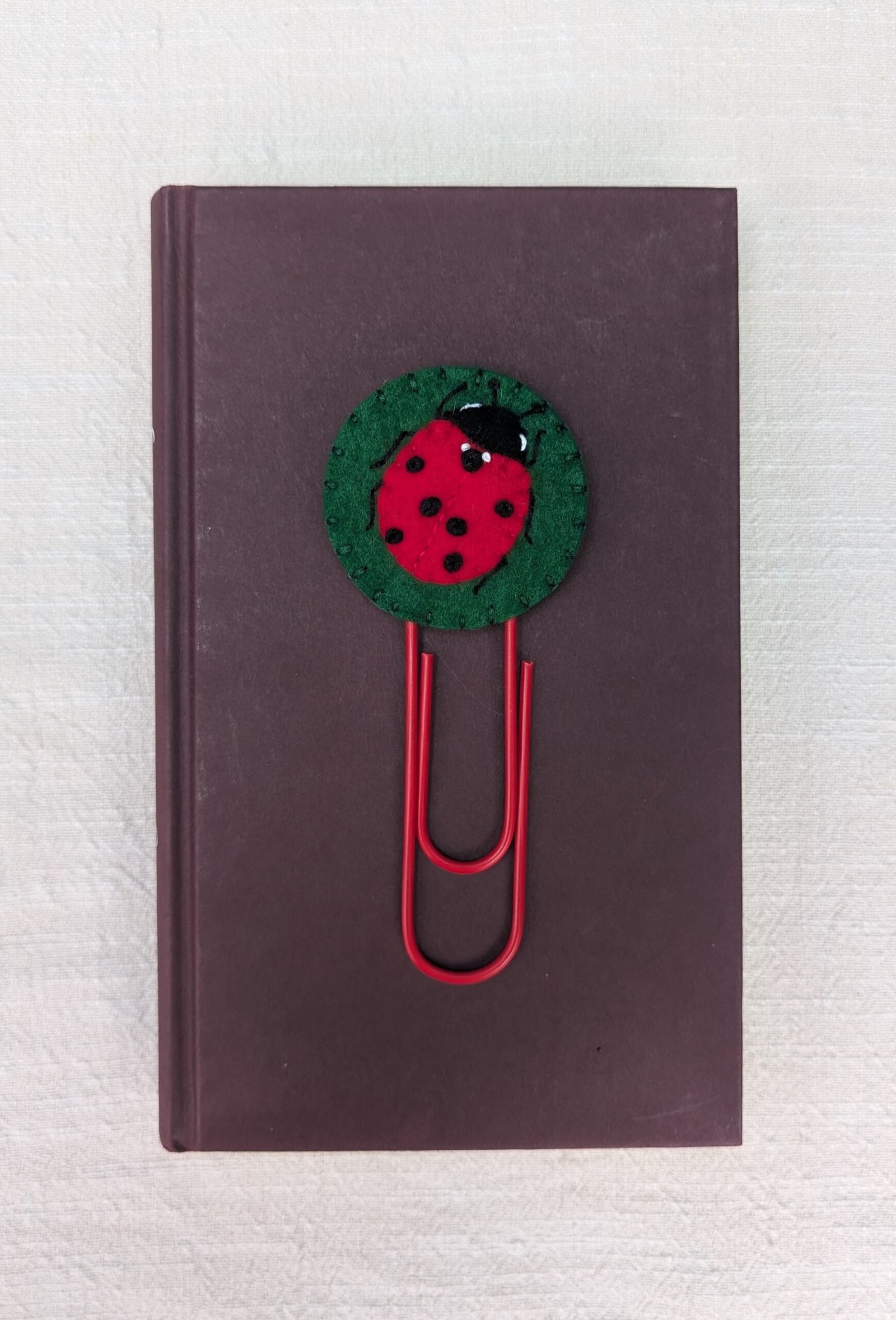 Wool felt topped jumbo paperclip bookmark with hand embroidered and appliqued ladybird motif
